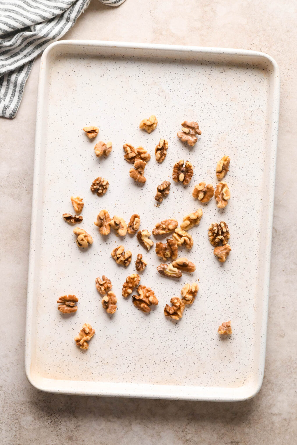 How to make Asian Pear and Walnut Salad with Maple Mustard Dressing: Walnuts spread in an even layer on a baking sheet to roast.