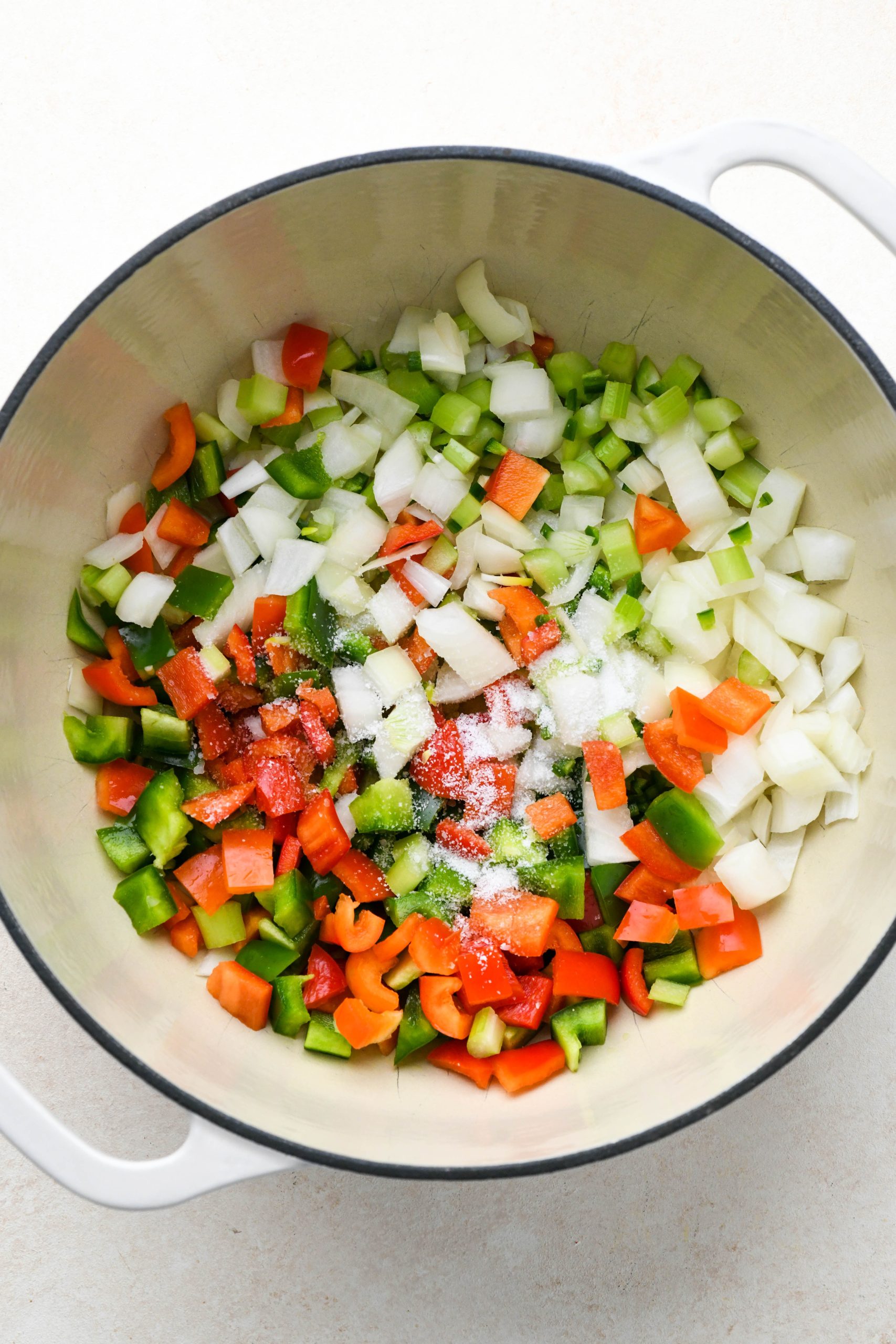 How to make vegan black bean soup: Raw veggies in a large soup pot.