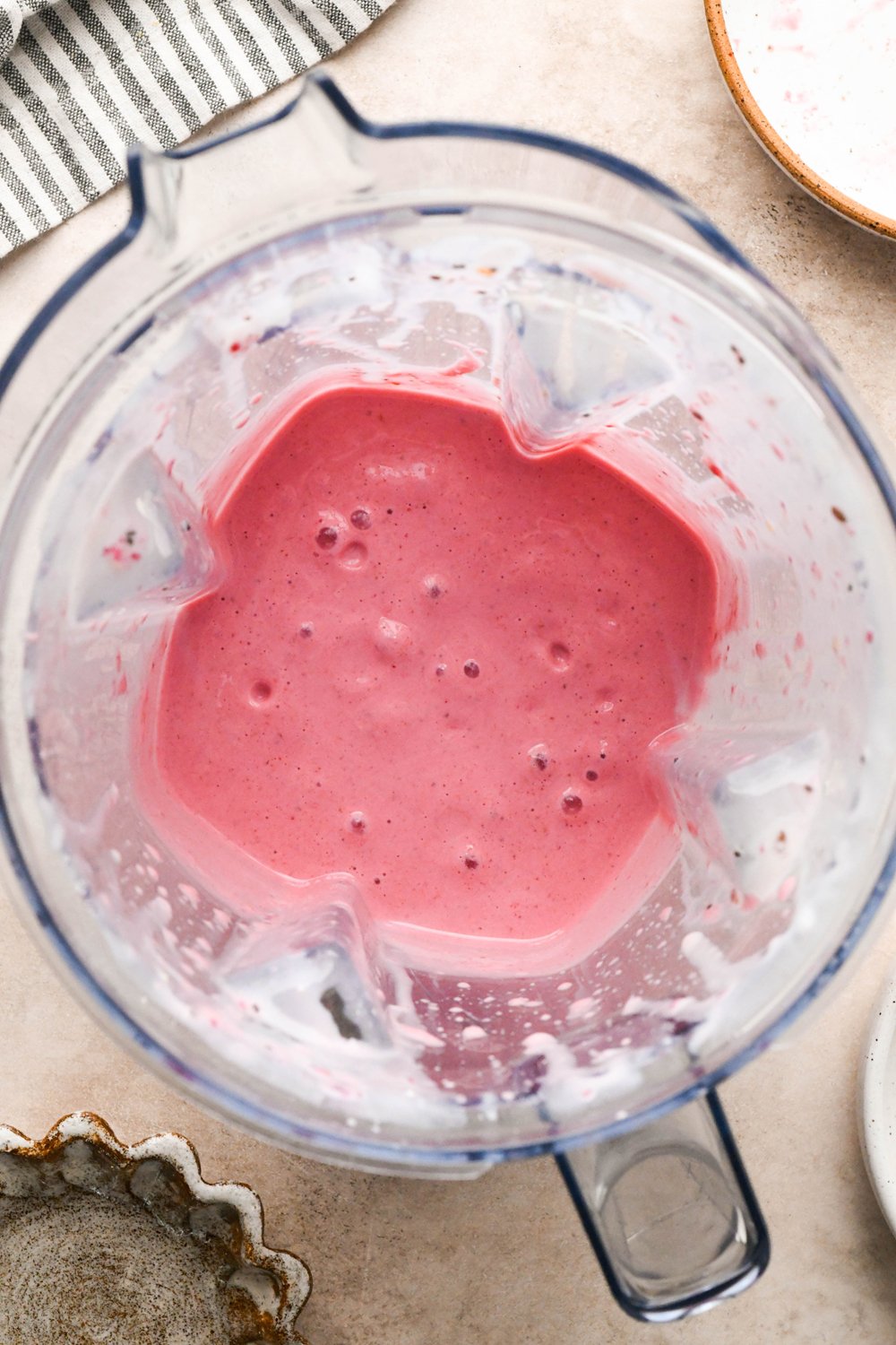 Step-by-step for how to make Raspberry Mango Smoothie with Greek Yogurt: Smoothie in blender container after blending until smooth. 