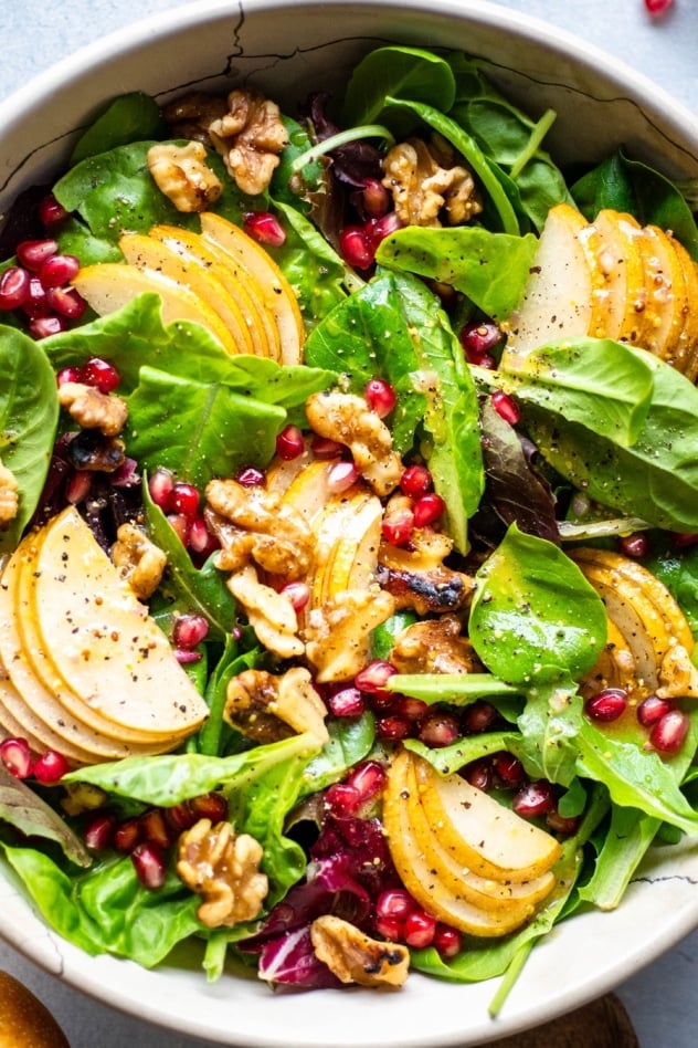 This asian pear and walnut salad with a maple mustard vinaigrette is fall salad DREAMS. Made with tender salad greens, thinly sliced asian pear, toasted walnuts, sweet pomegranate seeds, and a zippy maple mustard vinaigrette that you'll want to put on everything. 