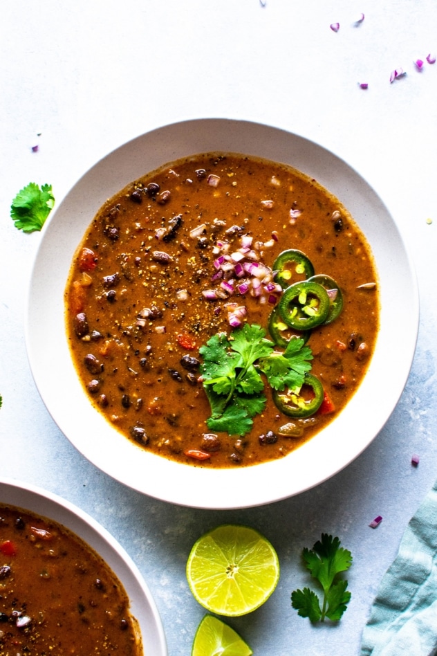 The best vegan black bean soup is made with simple ingredients like canned black beans, veggies and some flavorful spices. Hearty and full of flavor and nutrition! Top it with your favorite garnishes like cilantro, red onion and lots of lime for a satisfying and easy soup! 