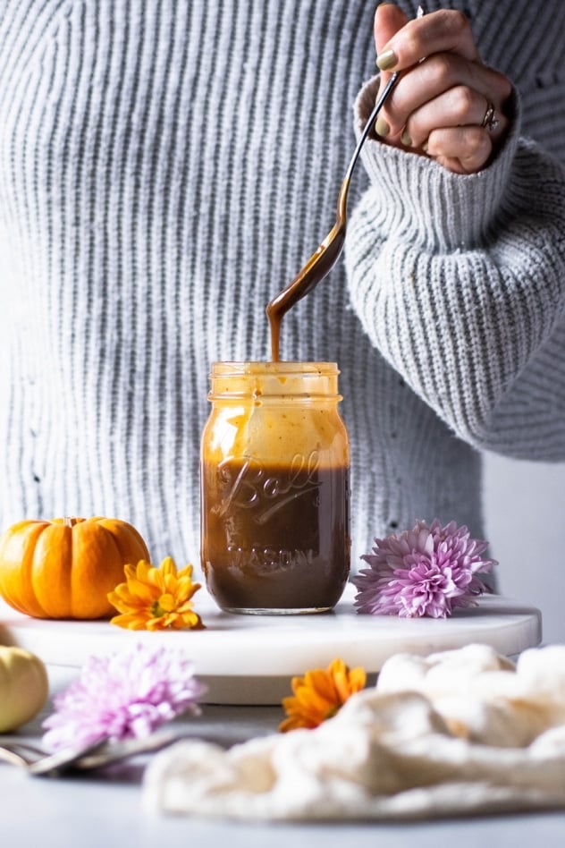 This paleo salted pumpkin caramel sauce is made with a few clean and simple ingredients like coconut milk, coconut sugar, real pumpkin, pumpkin spice, sea salt and vanilla extract. Easy to make and a healthy seasonal treat that you are going to LOVE dipping your spoon into!