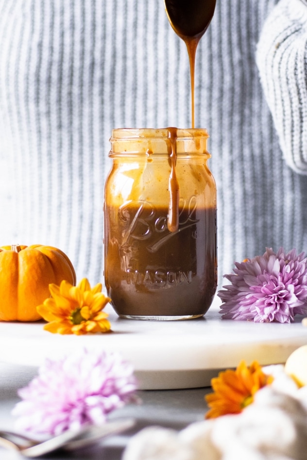 This paleo salted pumpkin caramel sauce is made with a few clean and simple ingredients like coconut milk, coconut sugar, real pumpkin, pumpkin spice, sea salt and vanilla extract. Easy to make and a healthy seasonal treat that you are going to LOVE dipping your spoon into!