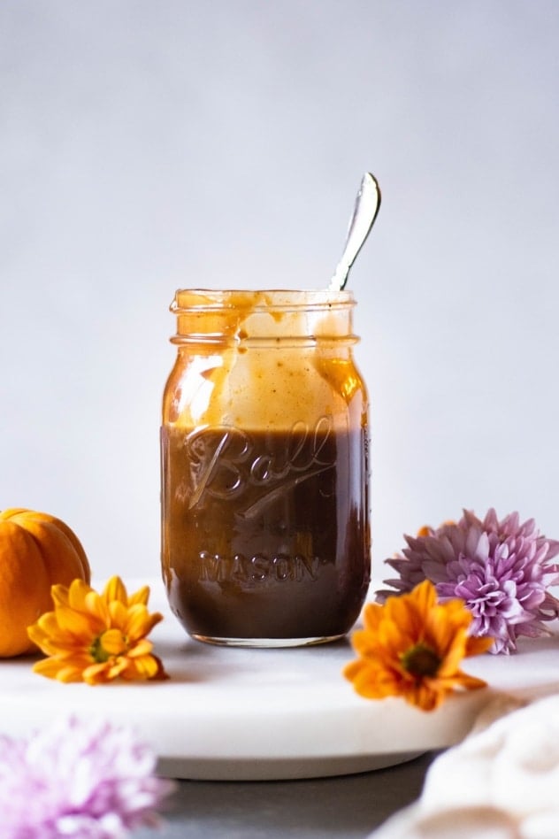 This paleo salted pumpkin caramel sauce is made with a few clean and simple ingredients like coconut milk, coconut sugar, real pumpkin, pumpkin spice, sea salt and vanilla extract. Easy to make and a healthy seasonal treat that you are going to LOVE dipping your spoon into!