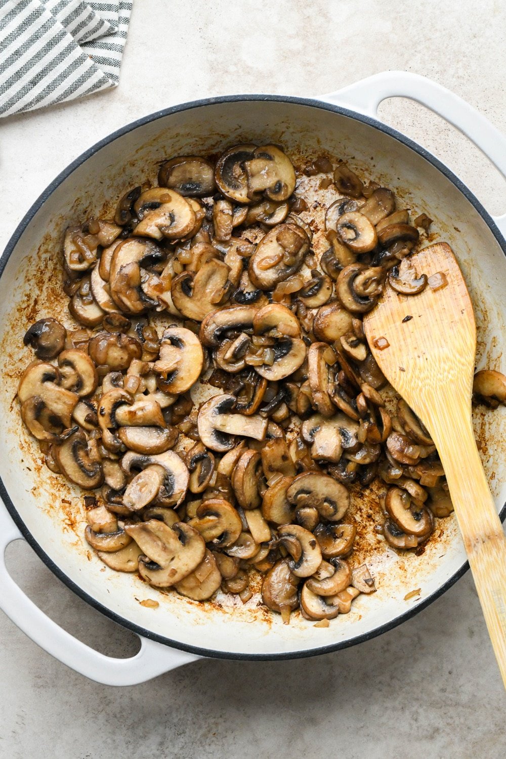 How to make Gluten Free Mushroom Gravy: Mushrooms and onions in a large skillet after sautéing until deeply golden brown.