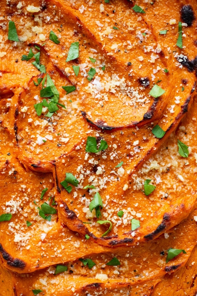 This twice baked garlic parmesan sweet potato casserole is a savory twist on a classic autumn side dish. Made with smooth and luscious sweet potatoes, parmesan cheese, and roasted garlic. Nourishing, delicious, and full of flavor! 
