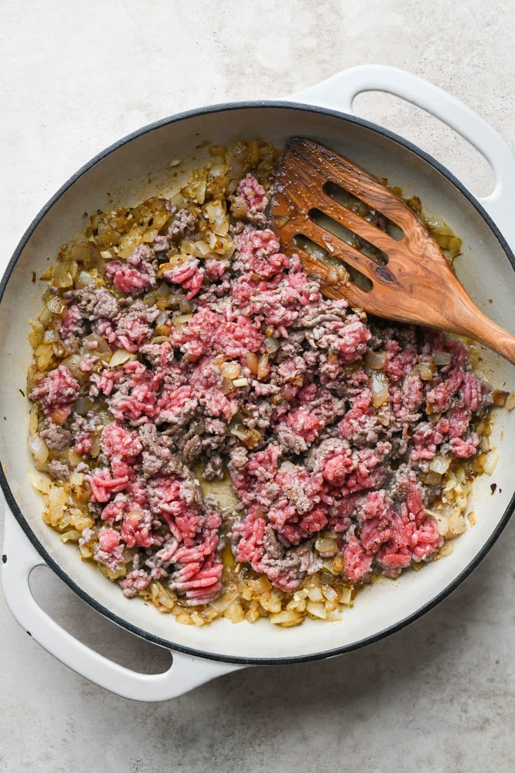 How to make Easy Marinara Sauce with Ground Beef: Ground beef being broken up while cooking.