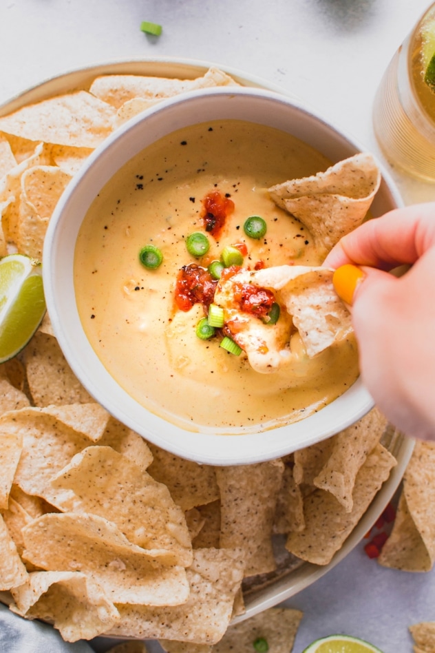This creamy cashew queso dip is made with ZERO processed ingredients, for an authentic tasting, full flavored, dairy free alternative to this well loved dip. SO crave worthy and made with anti-inflammatory, good-for-you ingredients! Vegan + whole30 compliant.
