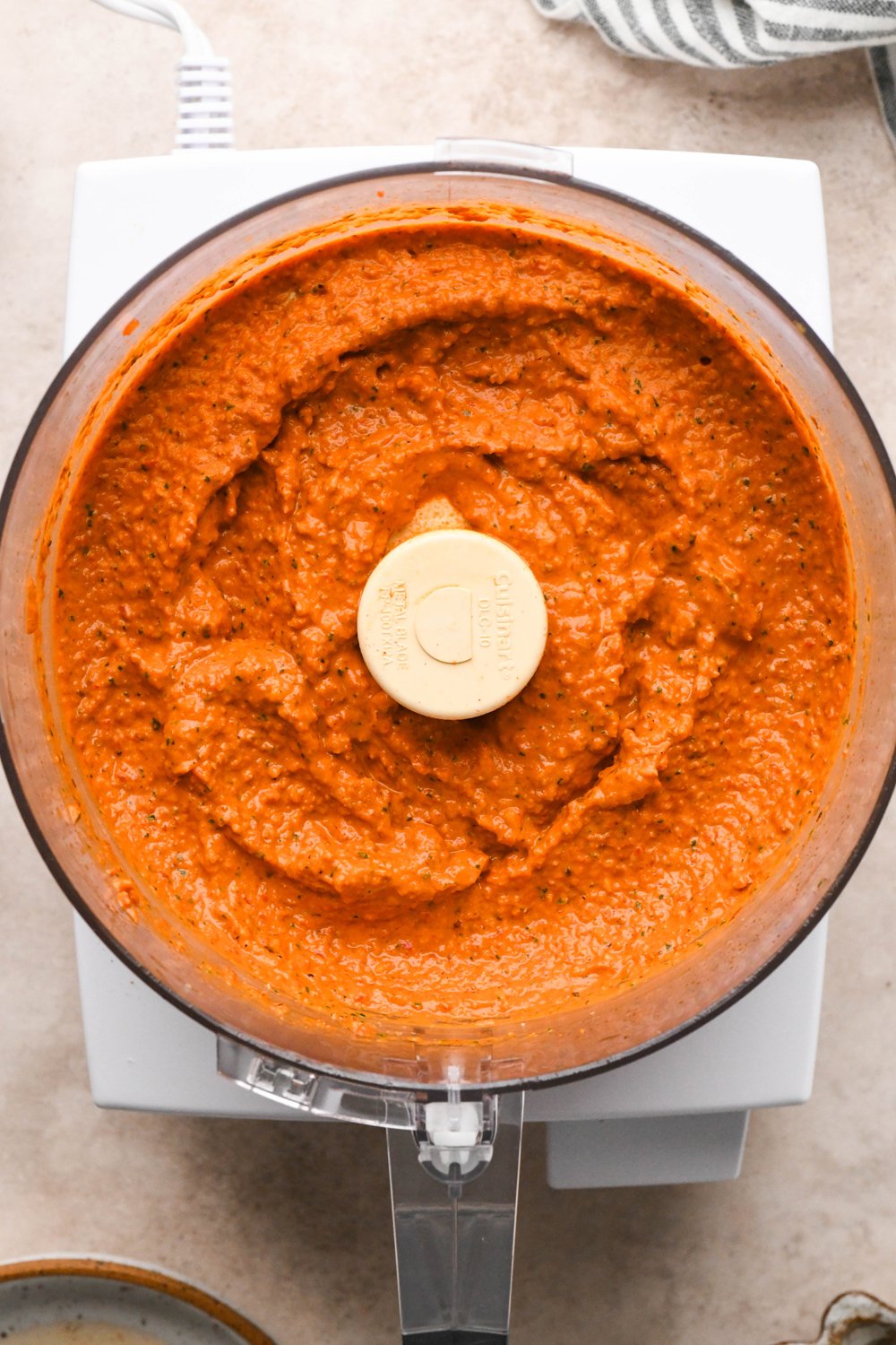 How to make Dairy Free Romesco Sauce: All ingredients in the container of a food processor after pulsing to combine.