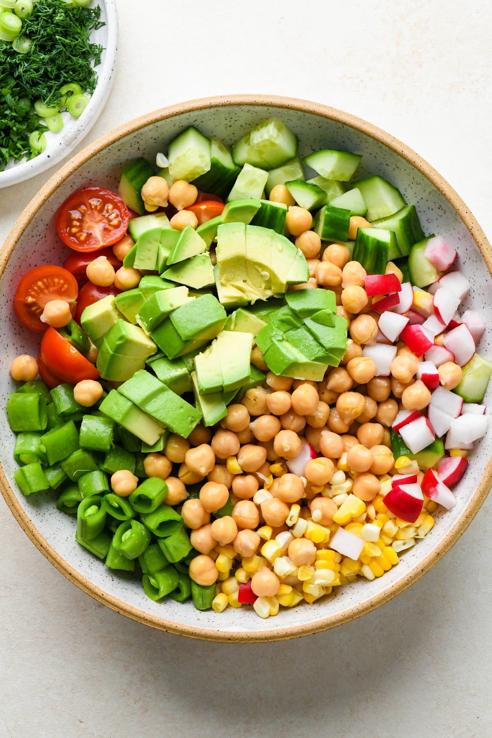 How to make vegan chickpea salad: Salad ingredients in a large bowl.