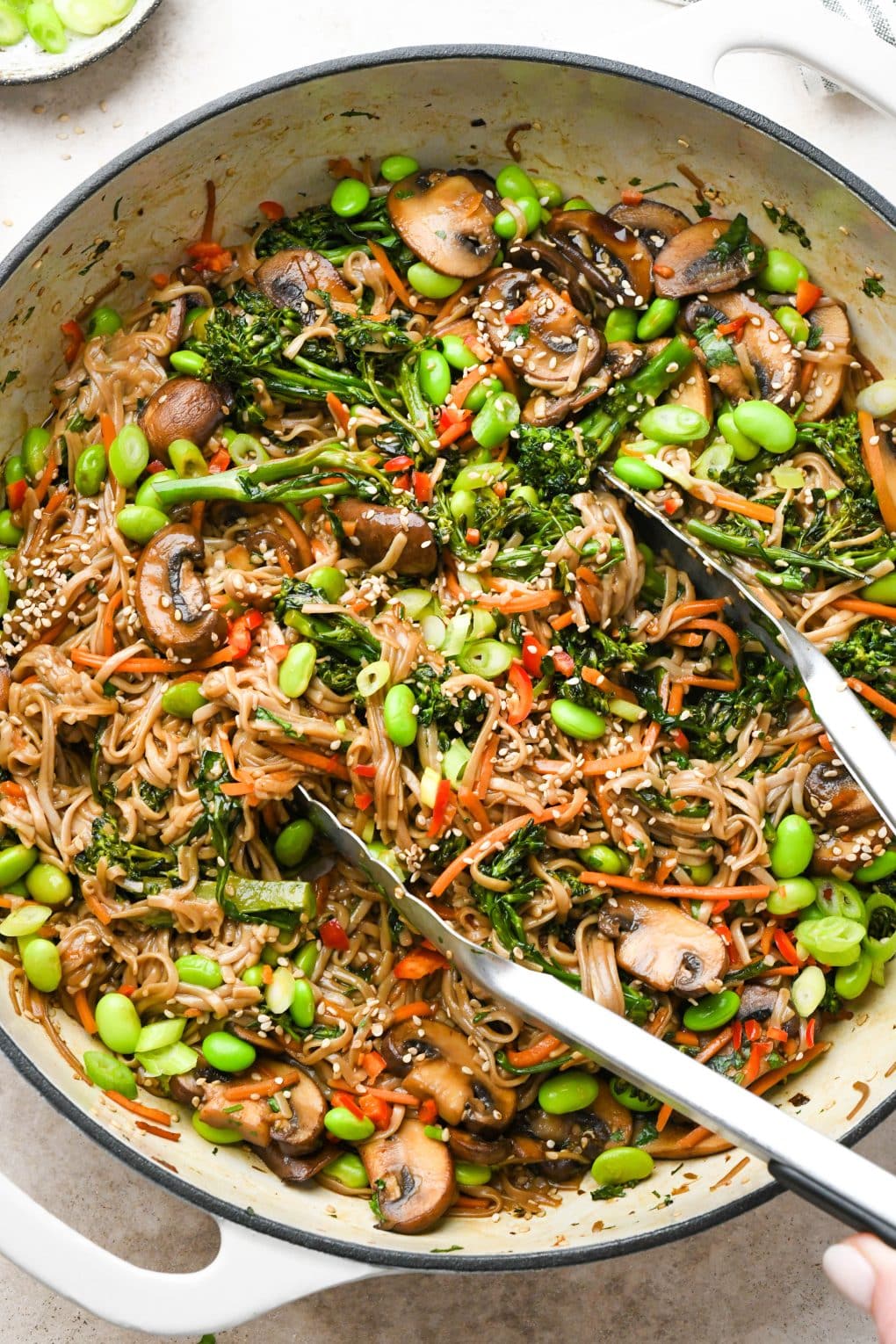 Overhead image of a large skillet filled with a colorful soba noodle stir fry.