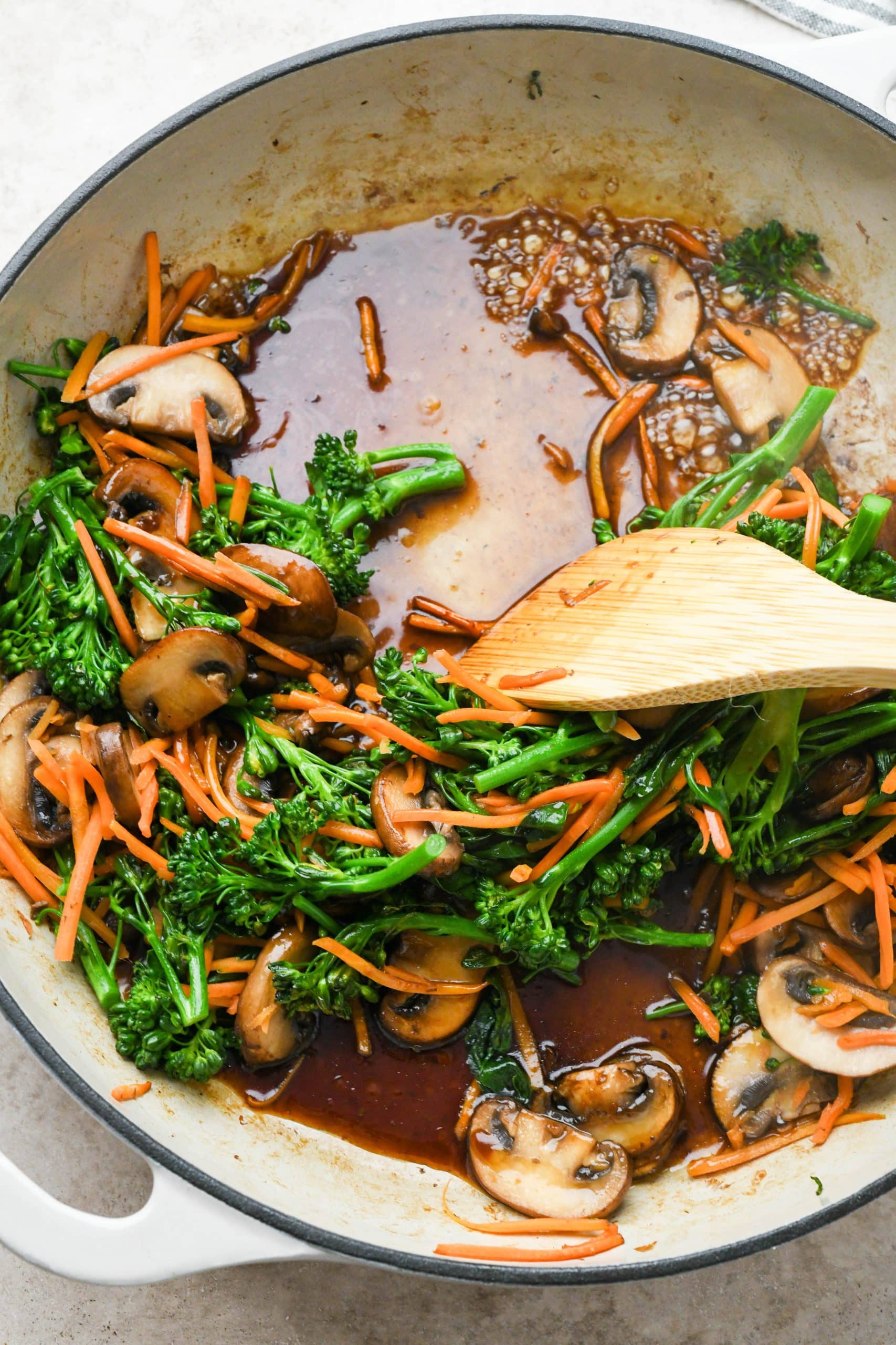 How to make soba noodle stir fry: Stir fry sauce in skillet with cooked veggies.