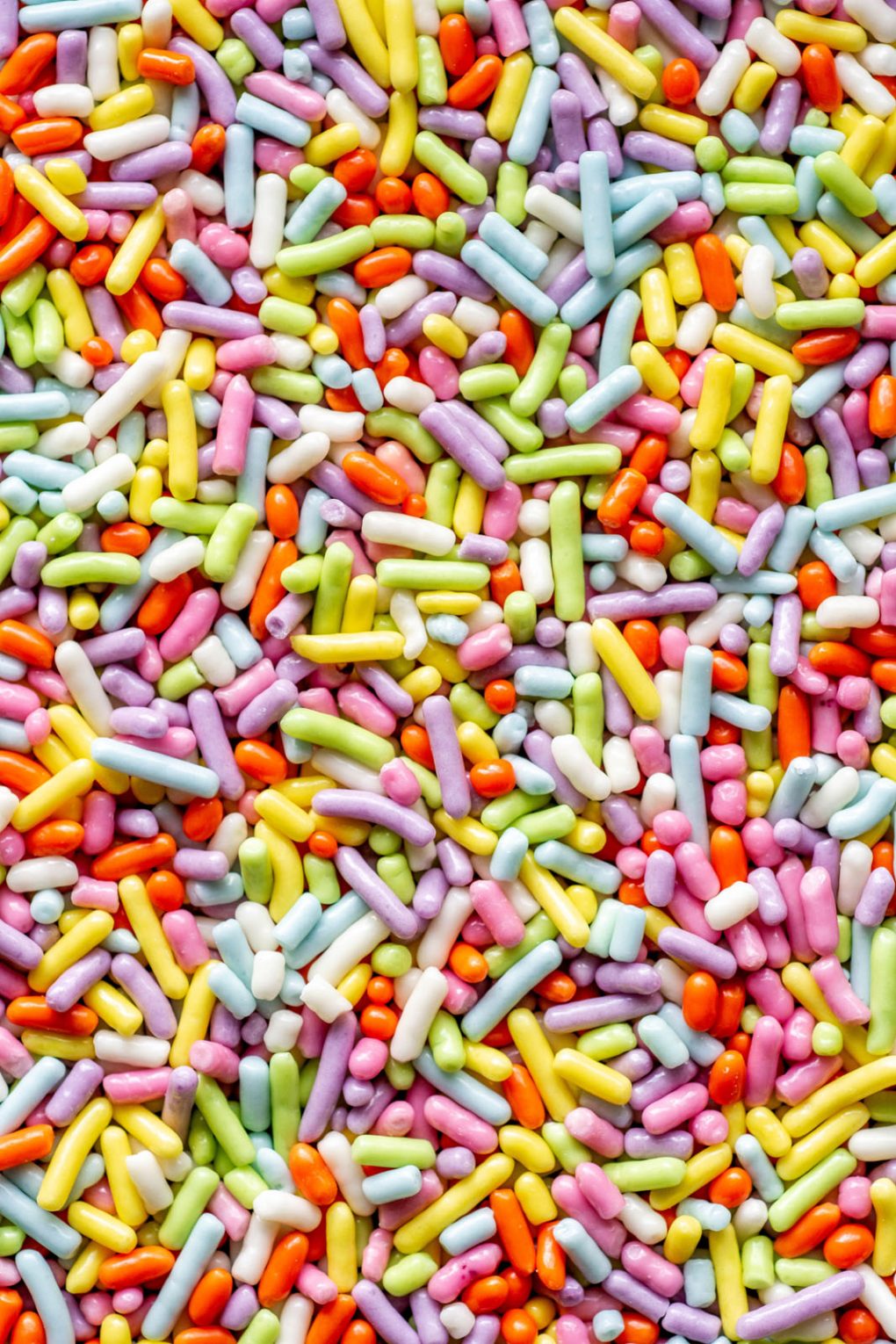 Close up shot of pastel rainbow colored sprinkles