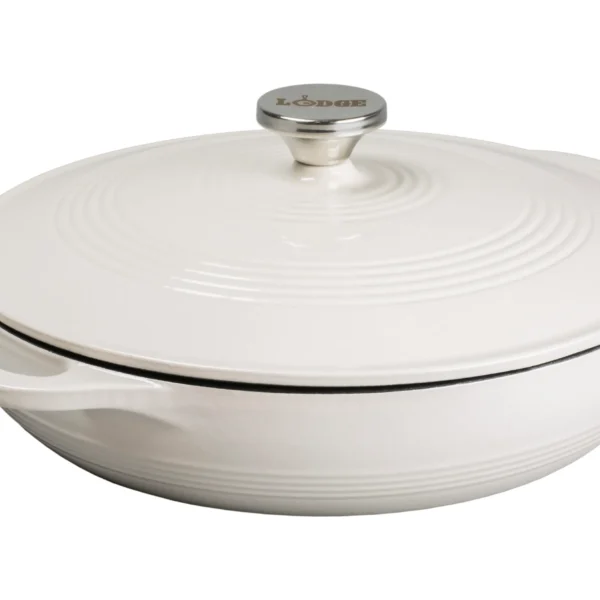 A round white enameled cast iron Dutch oven with a lid and side handles, featuring a metal knob labeled Lodge on top.