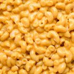 A close-up of gluten-free elbow macaroni covered in creamy orange dairy-free cheese sauce.
