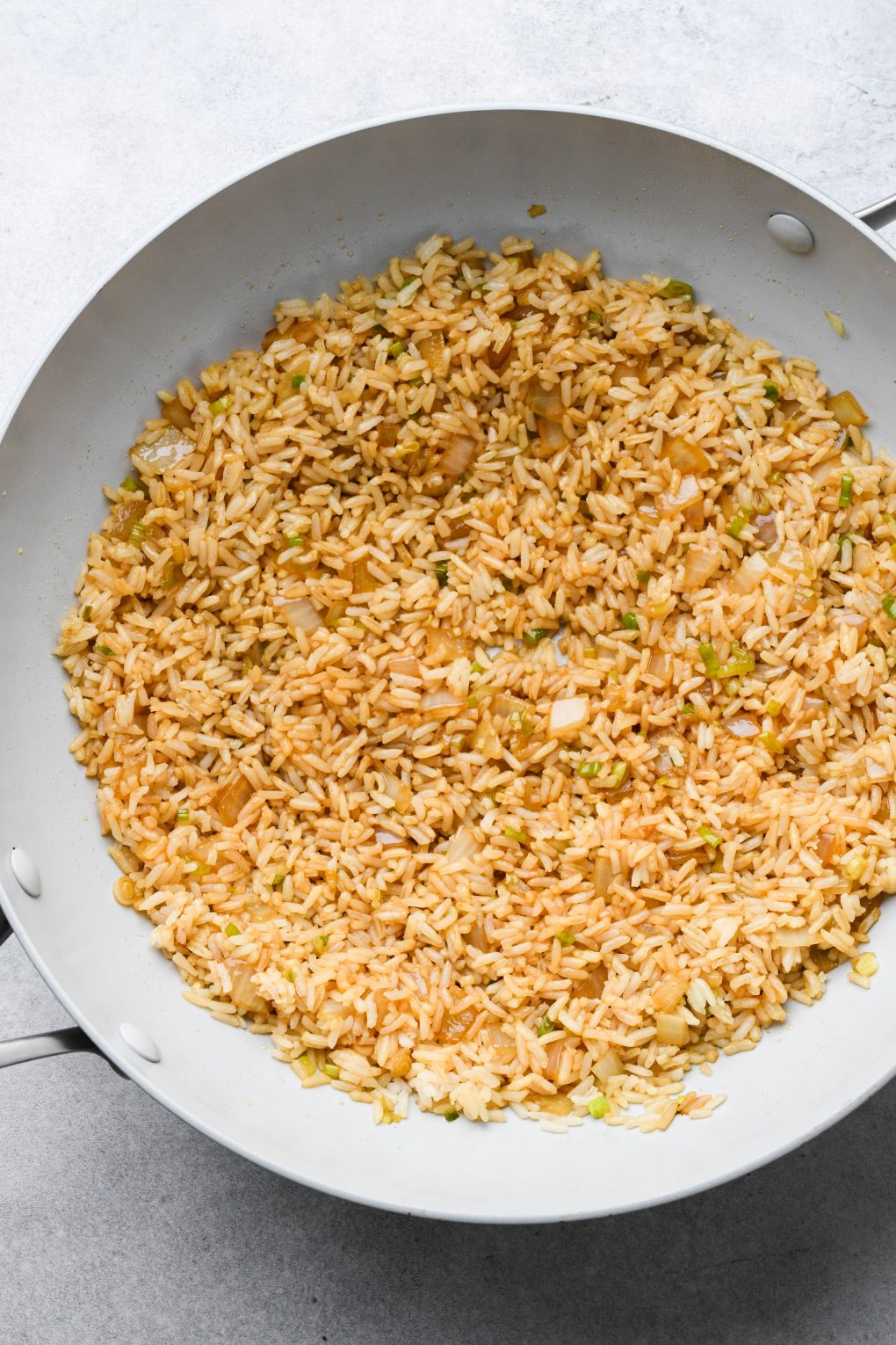 Wok with rice tossed with tamari and pressed into a thin layer