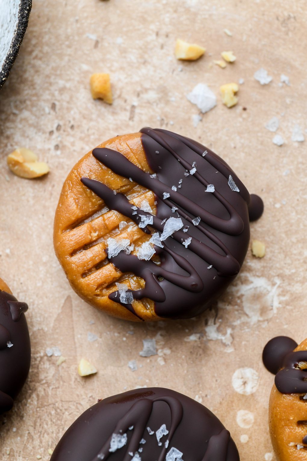 A single chocolate dipped no bake peanut butter cookie topped with flaky sea salt. 