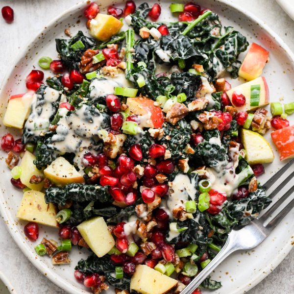 Kale apple and pomegranate salad on a small salad plate