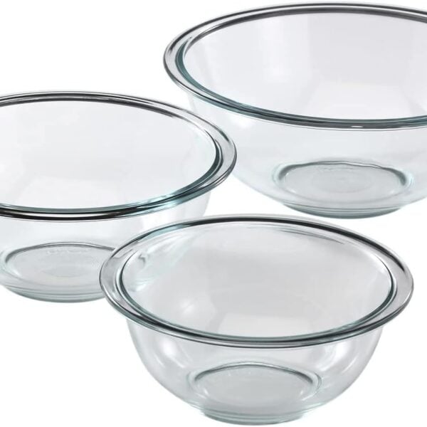 Three clear glass mixing bowls of different sizes are arranged on a white background. Each bowl has a rounded shape and a slightly flared rim.