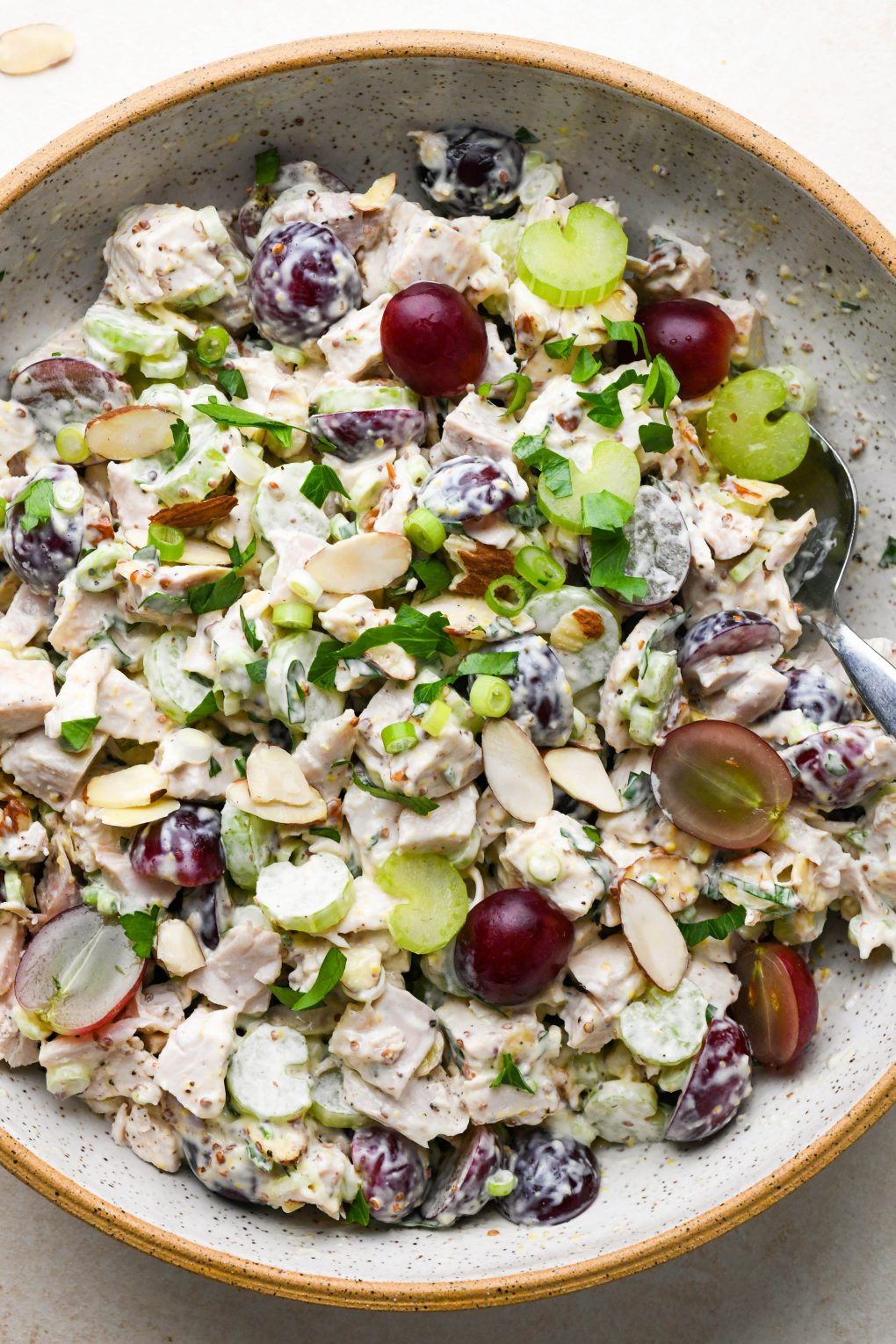 Chicken salad with grapes in a large ceramic speckled bowl