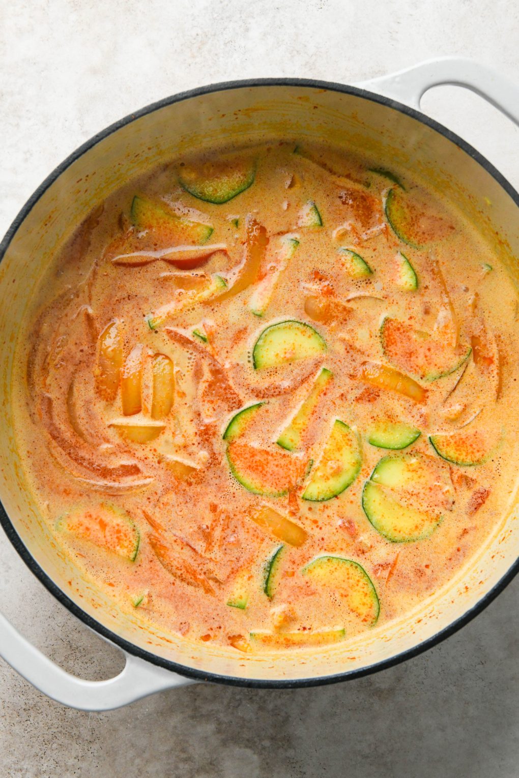 How to make Thai Coconut Curry Chicken Soup: Coconut milk mixed into curry soup.