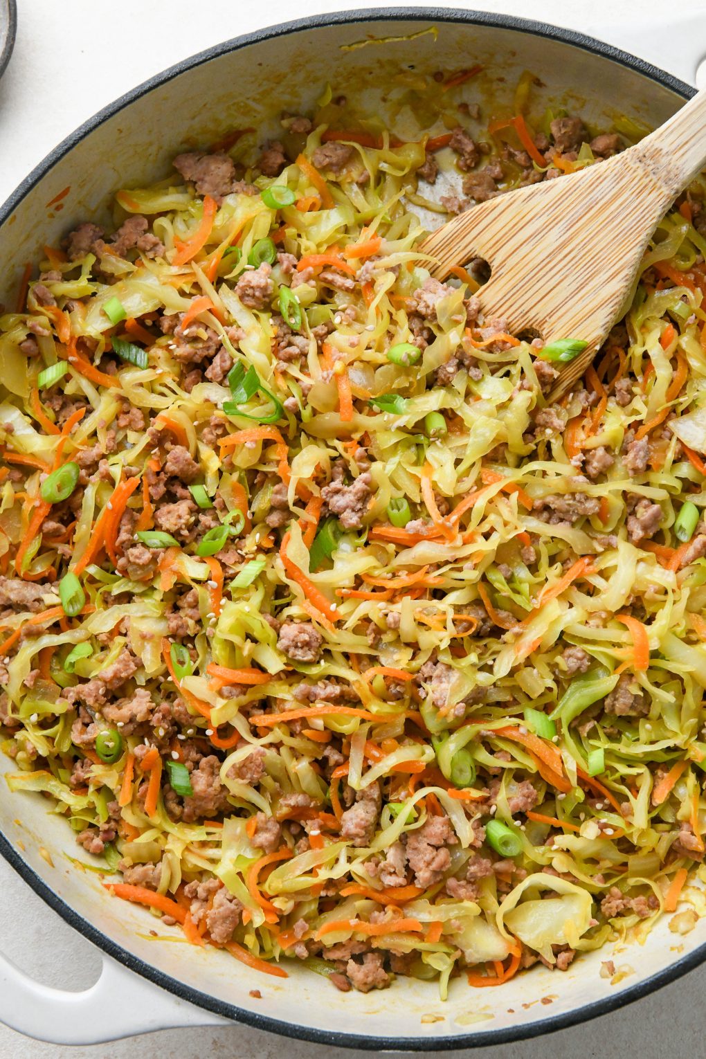 How to make Egg Roll in a Bowl: Cabbage and carrots tender and wilted, and topped with green onions and sesame seeds.