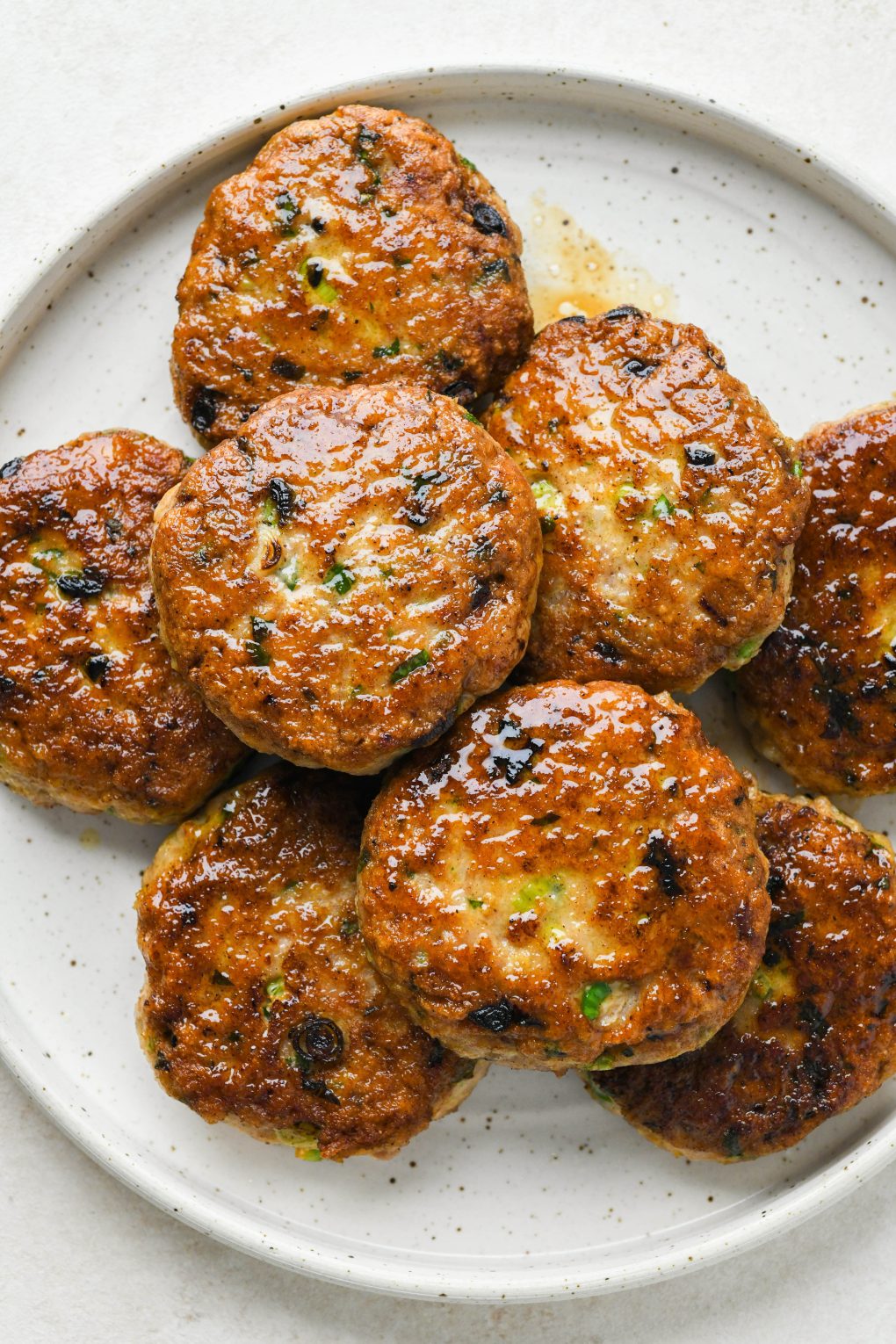 How to make healthy chicken patties: Cooked patties on a plate.