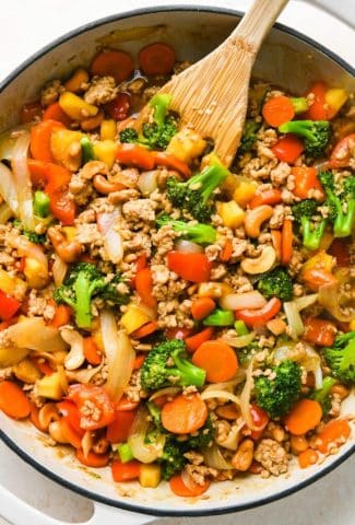 How to make healthy cashew chicken stir fry: Finished cashew chicken stir fry in a skillet.