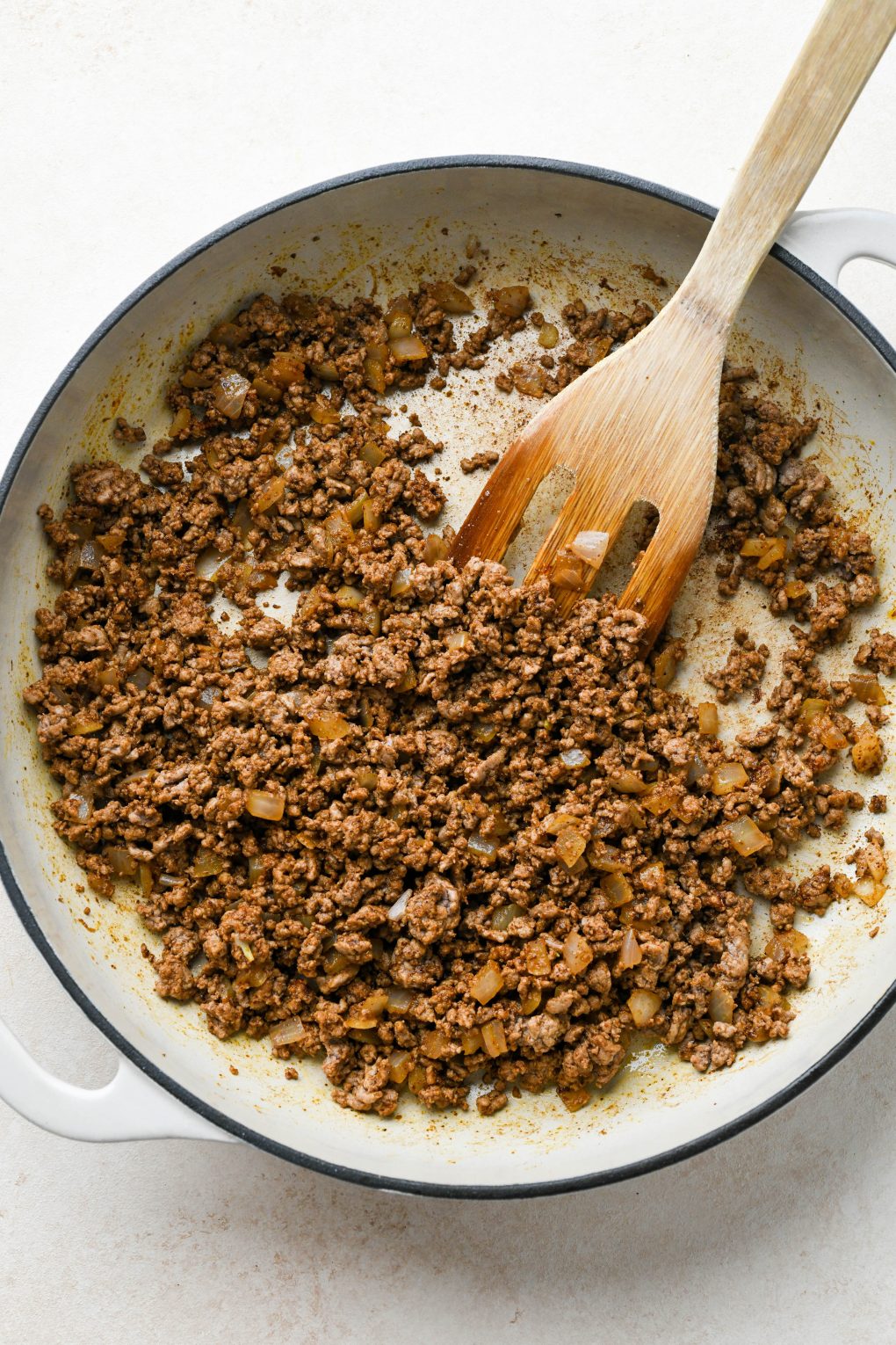 How to make Dairy Free Queso Fundido with Ground Beef: Cooked ground beef and onion in skillet with spices mixed in.