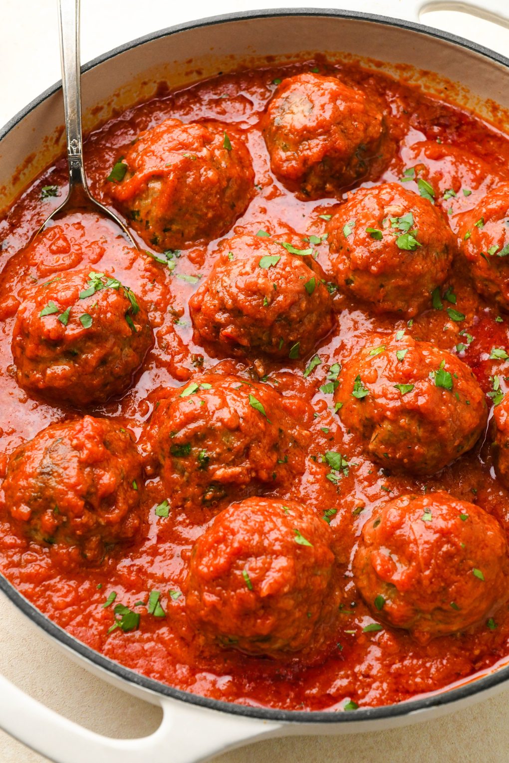 Gluten free meatballs in tomato sauce in a large skillet.