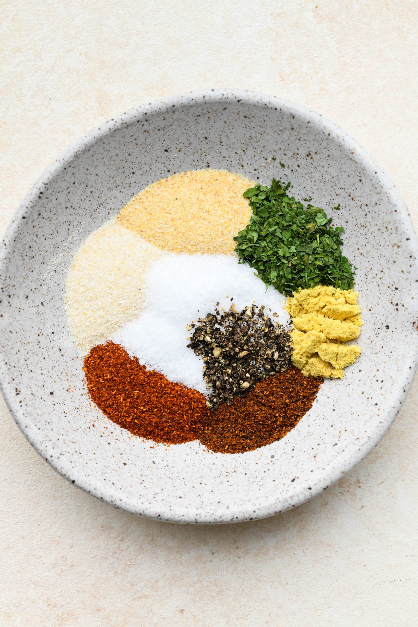 Spices for baked chicken breasts in a small ceramic dish