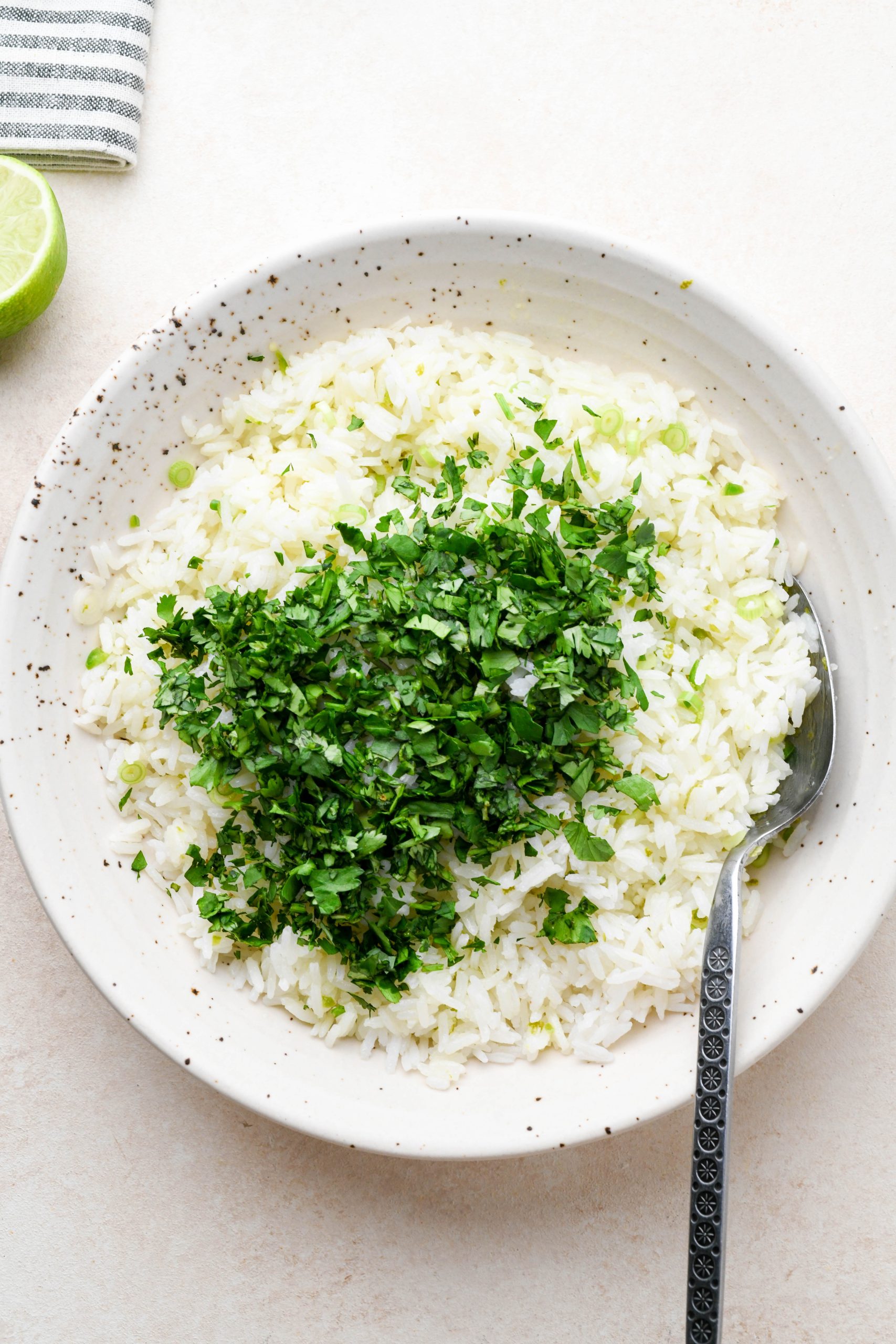 How to make cilantro lime rice: White rice and lime juice mixture topped with fresh cilantro.