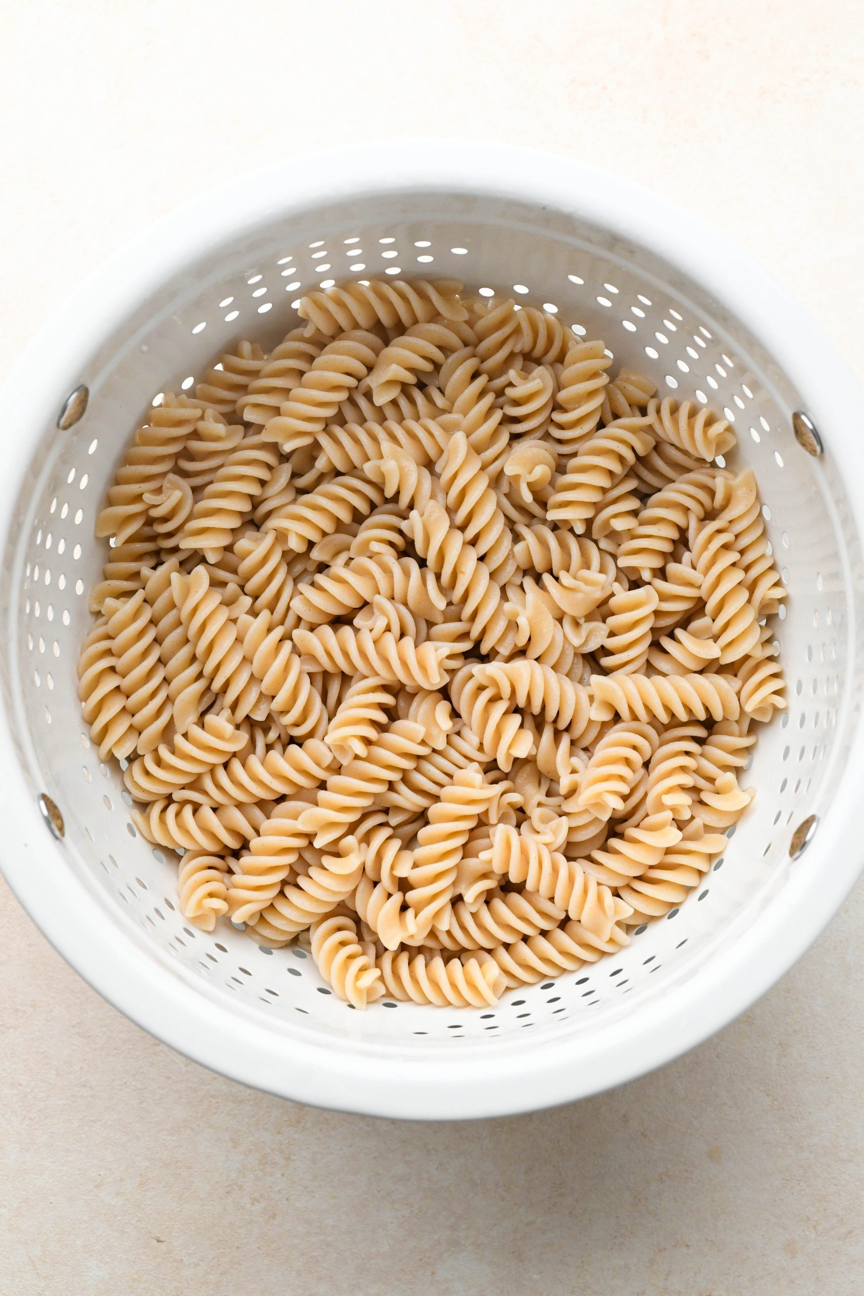 How to make Easy Gluten Free Italian Pasta Salad: GF fusilli pasta cooked and drained in a colander.