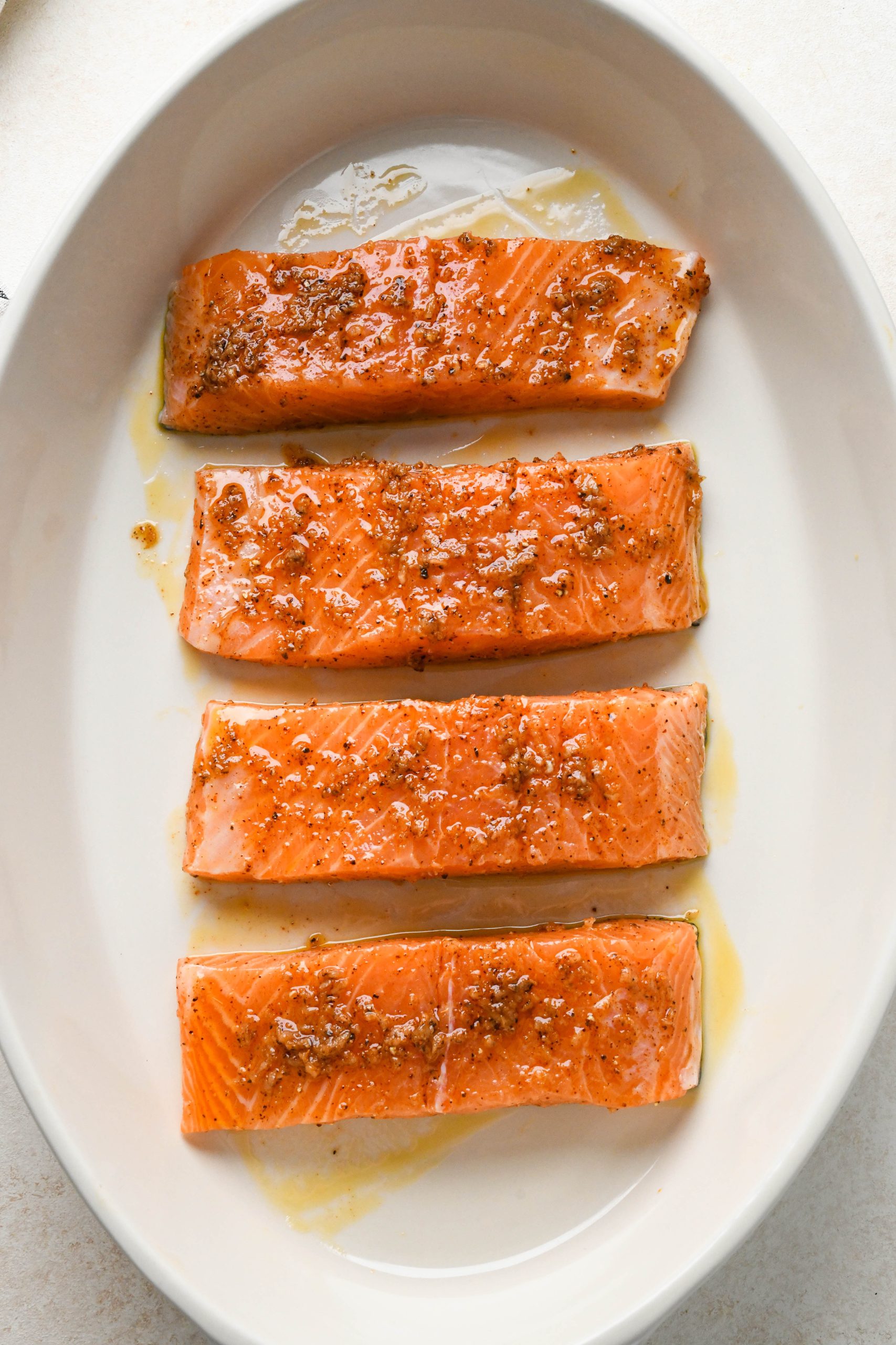How to make baked salmon: Coated salmon fillets before baking in a baking dish.