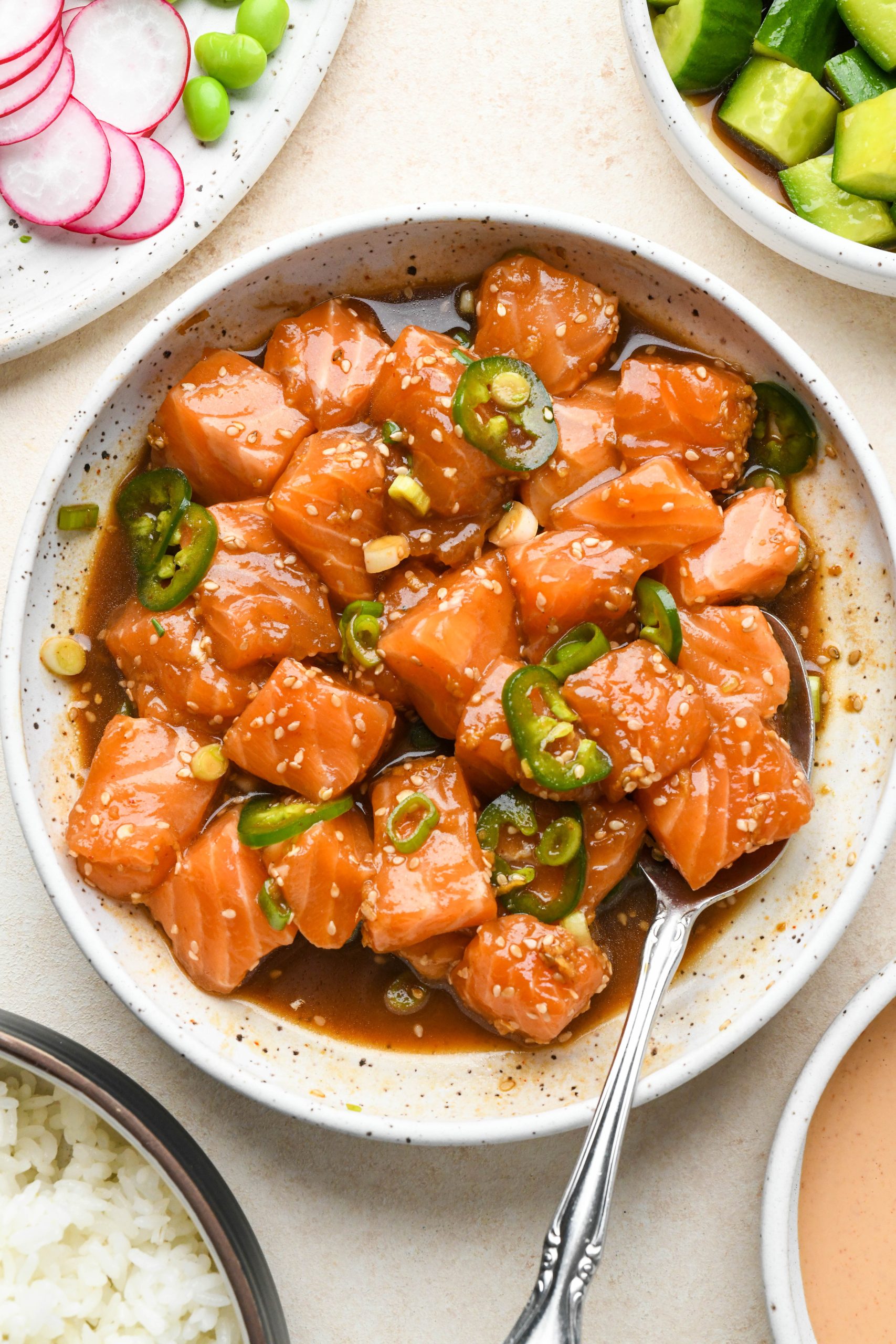 How to make poke bowls: Marinated salmon poke in a shallow bowl.