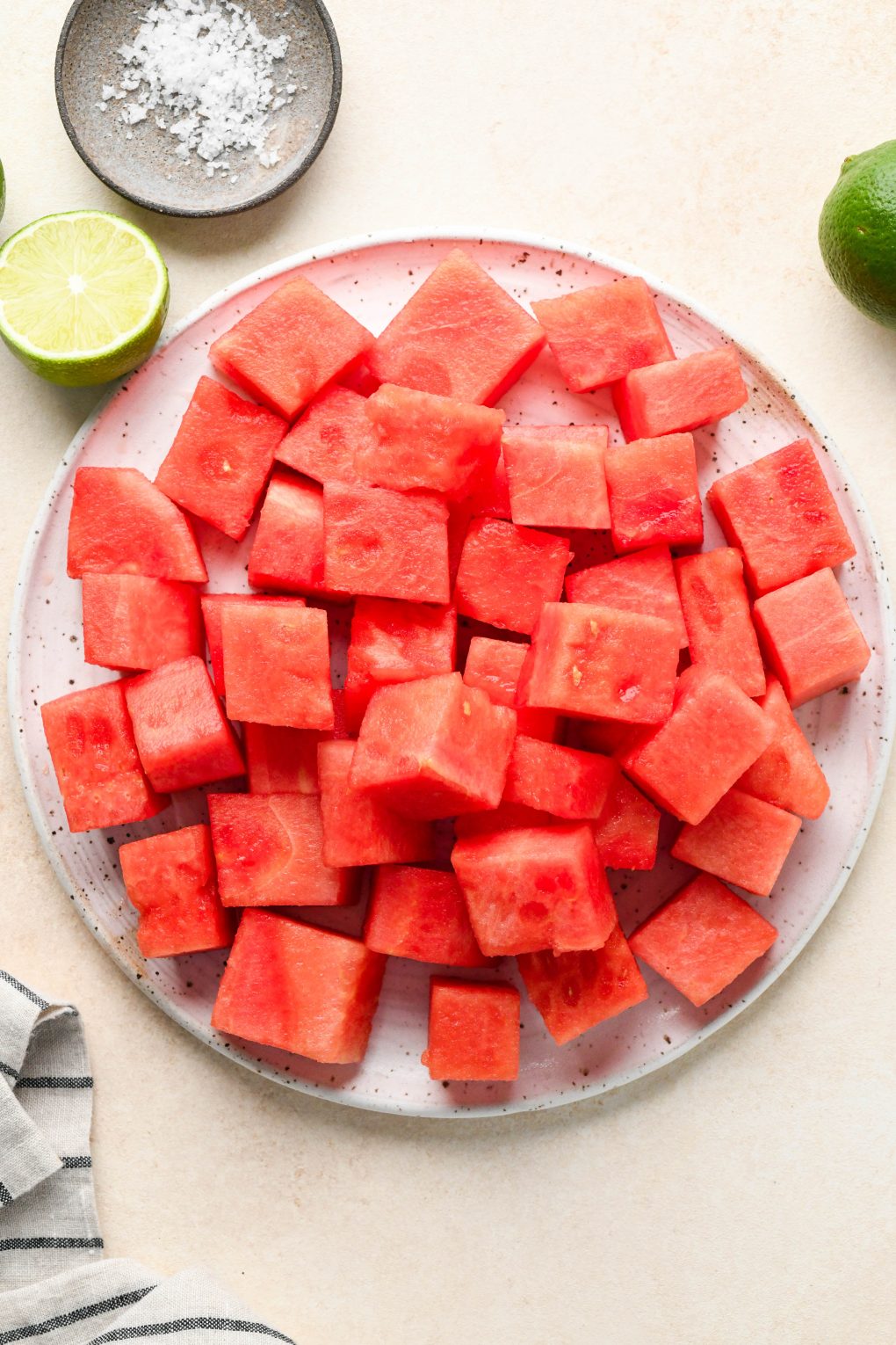 Ingredients for watermelon juice on various sized ceramics.
