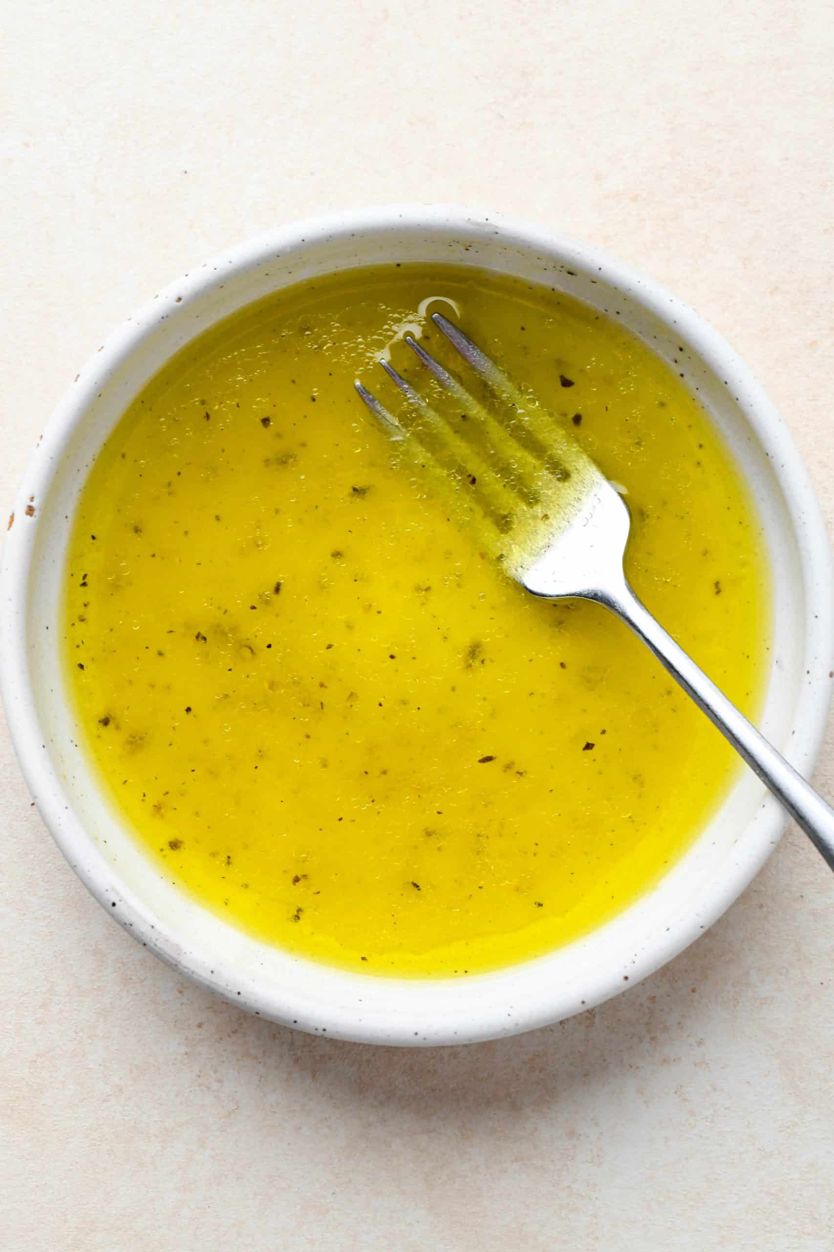 How to make Simple Arugula Salad: Salad dressing ingredients in a small bowl after mixing.
