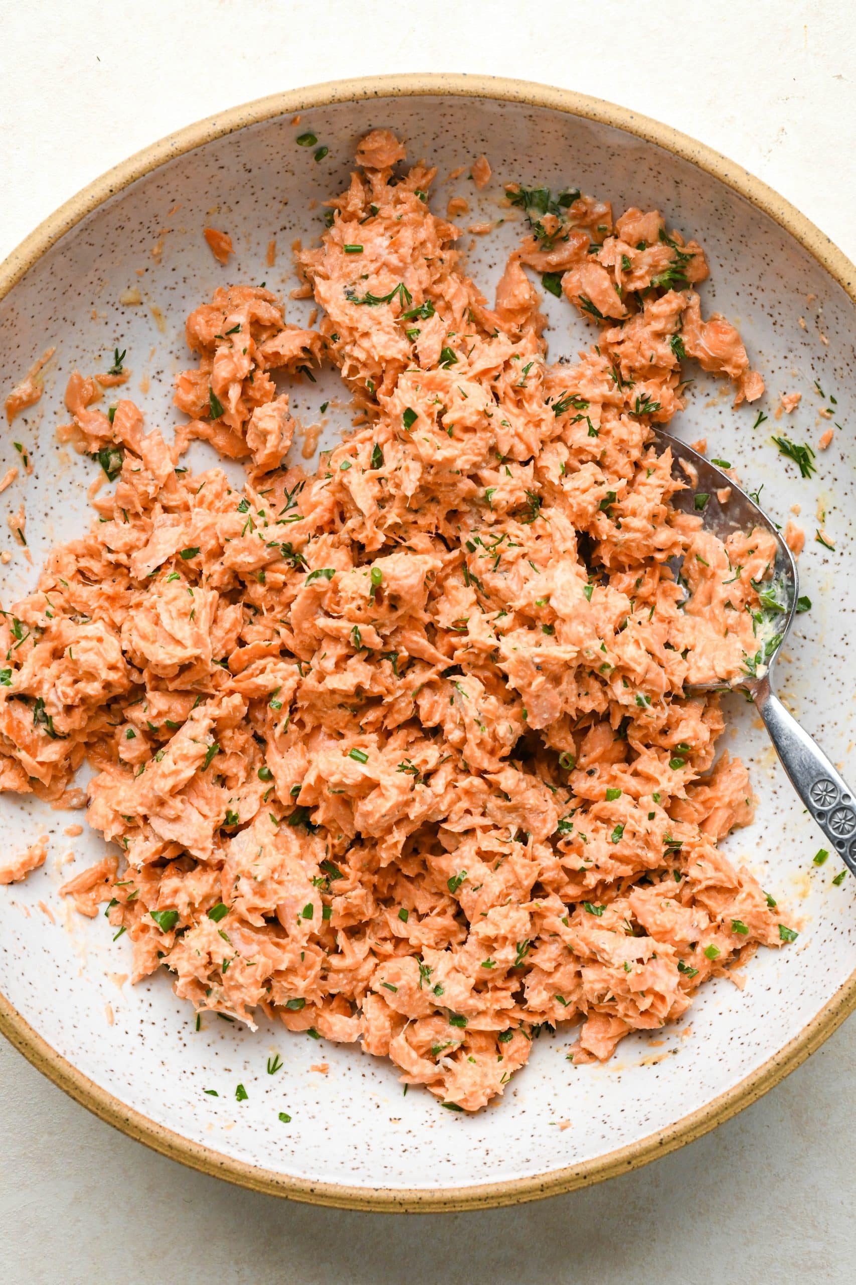 How to make Whole30 Salmon Cakes: All ingredients for salmon cakes in a large bowl, after mixing.