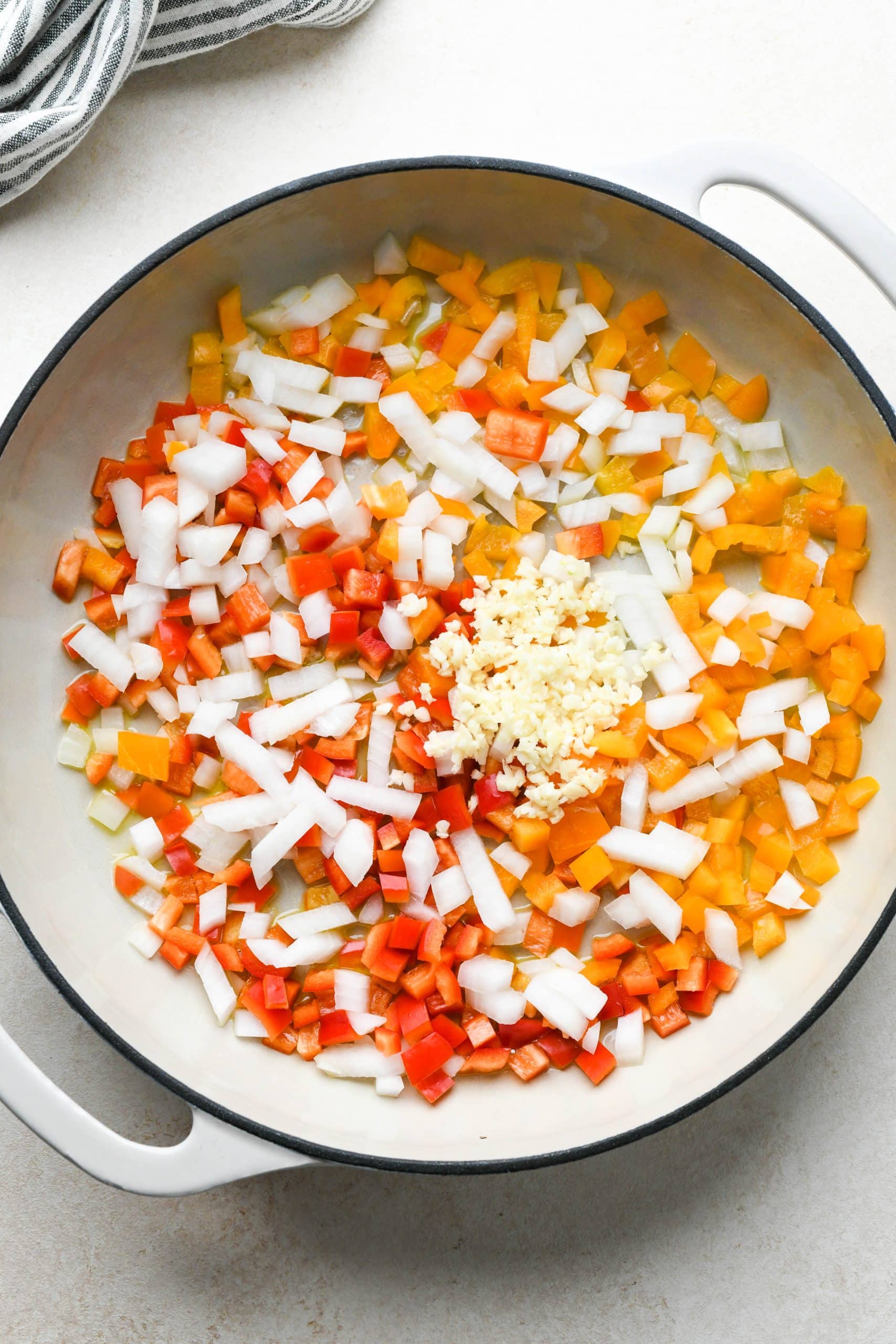 How to make buffalo chicken pasta: Bell peppers, onion, and garlic in a large shallow skillet before cooking.