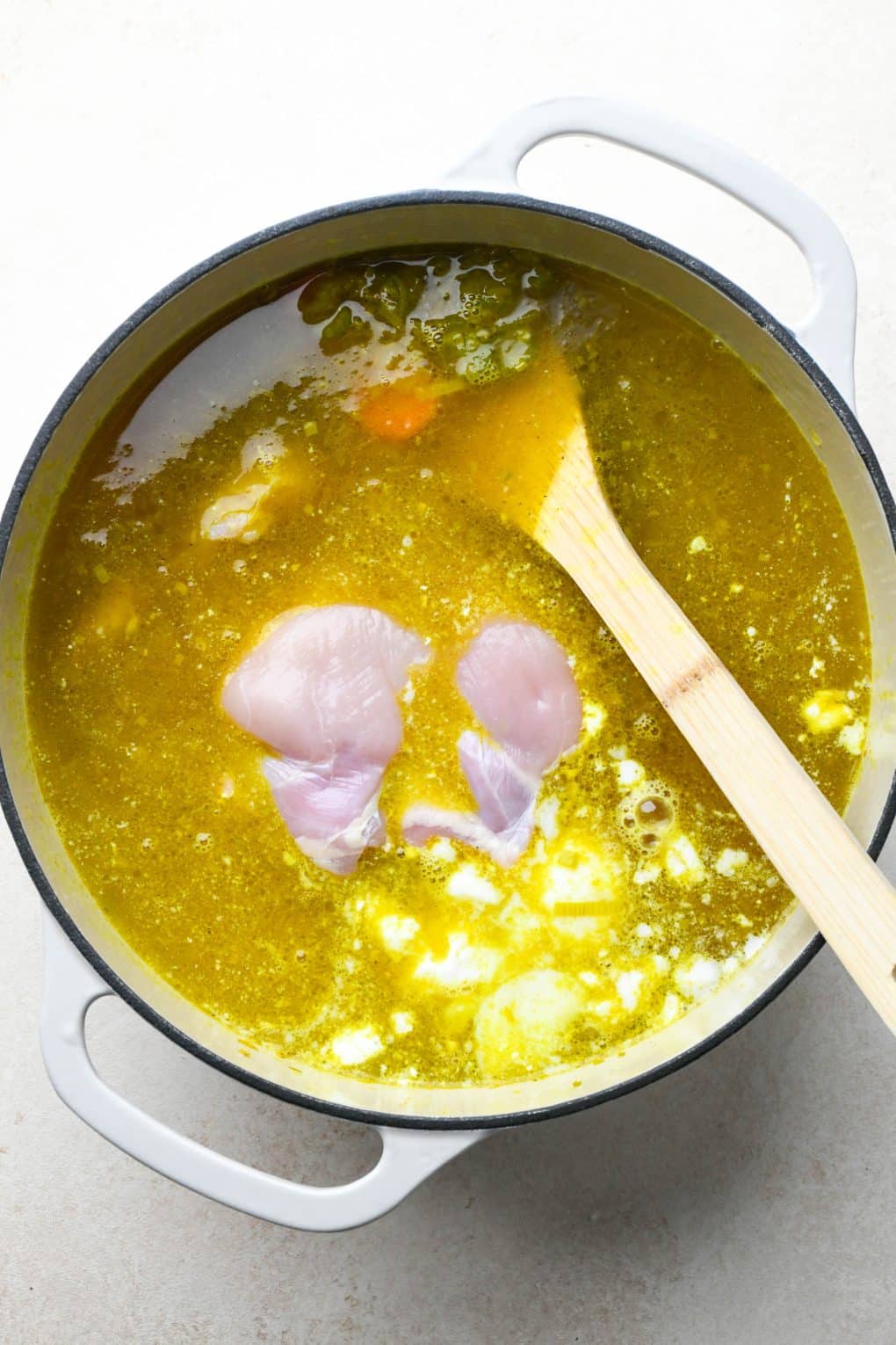 How to make Anti Inflammatory Turmeric Chicken Soup: Chicken thighs and coconut milk added to the soup pot. 