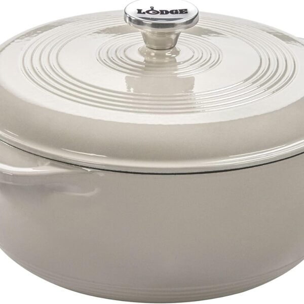 A round, cream-colored enameled cast iron Dutch oven with a matching lid and handle. The brand Lodge is printed on the knob on top of the lid.