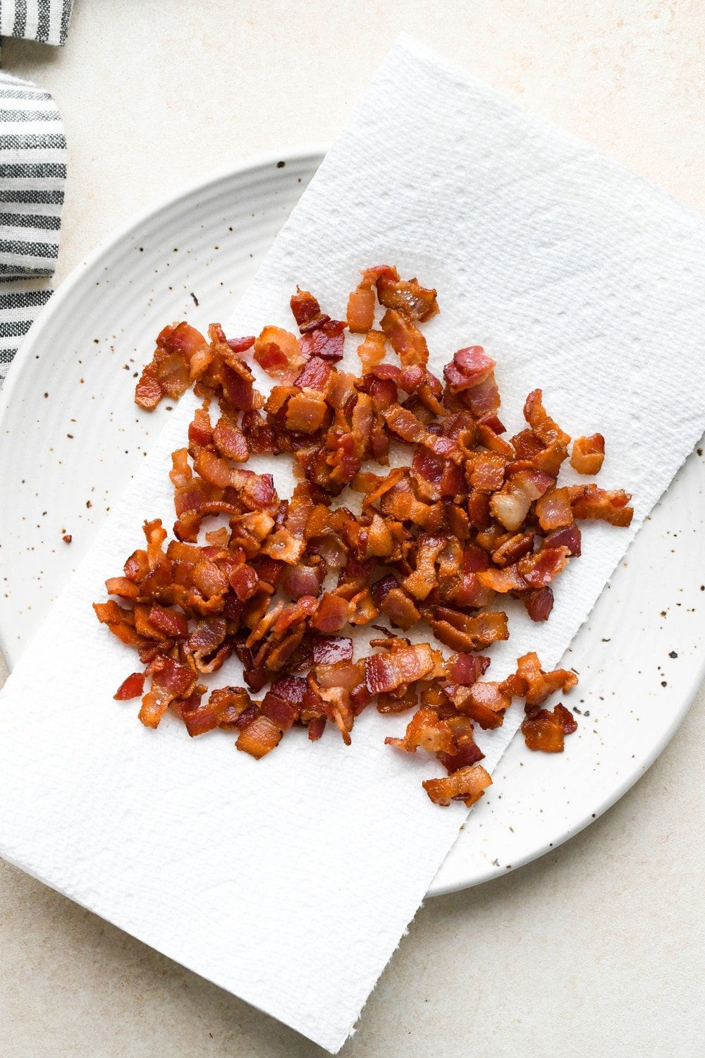 How to make Dairy Free Butternut Squash Pasta: Cooked bacon on a paper towel lined plate.