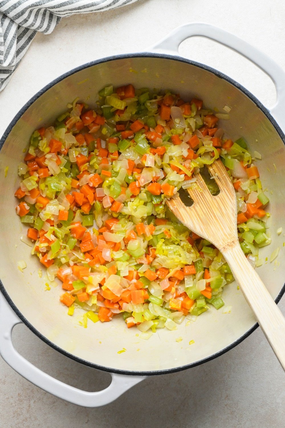 How to make Gluten Free Minestrone Soup: prepared carrots, celery, onions, and leeks in a large soup pot with olive oil after sautéing. 