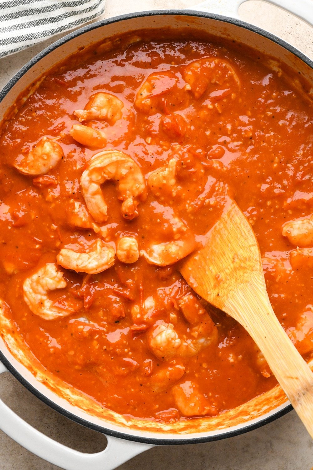 How to make Burst Cherry Tomato Shrimp Pasta: Shrimp cooked until opaque in burst cherry tomato sauace.