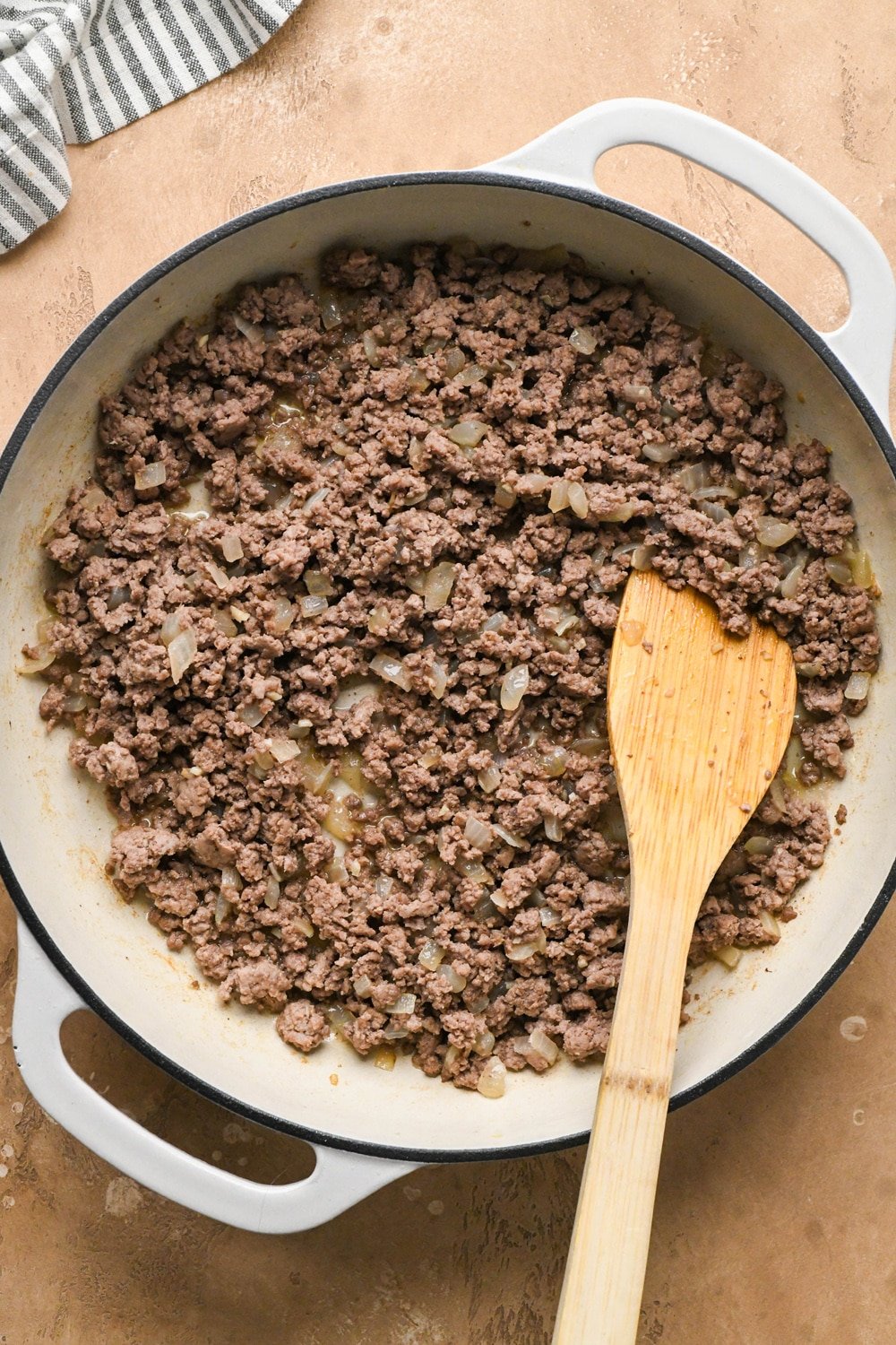 How to make dairy free hamburger helper: Cooked ground beef with onions and garlic in large ceramic coated cast iron skillet.