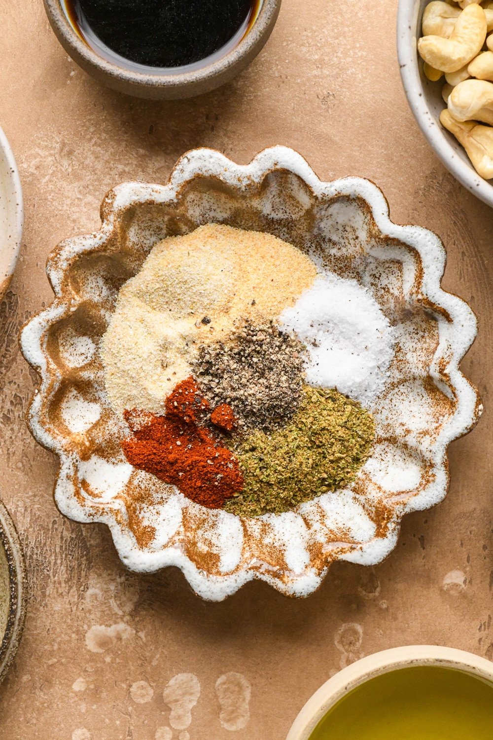 Spices for hamburger helper in a small brown ceramic spice dish.