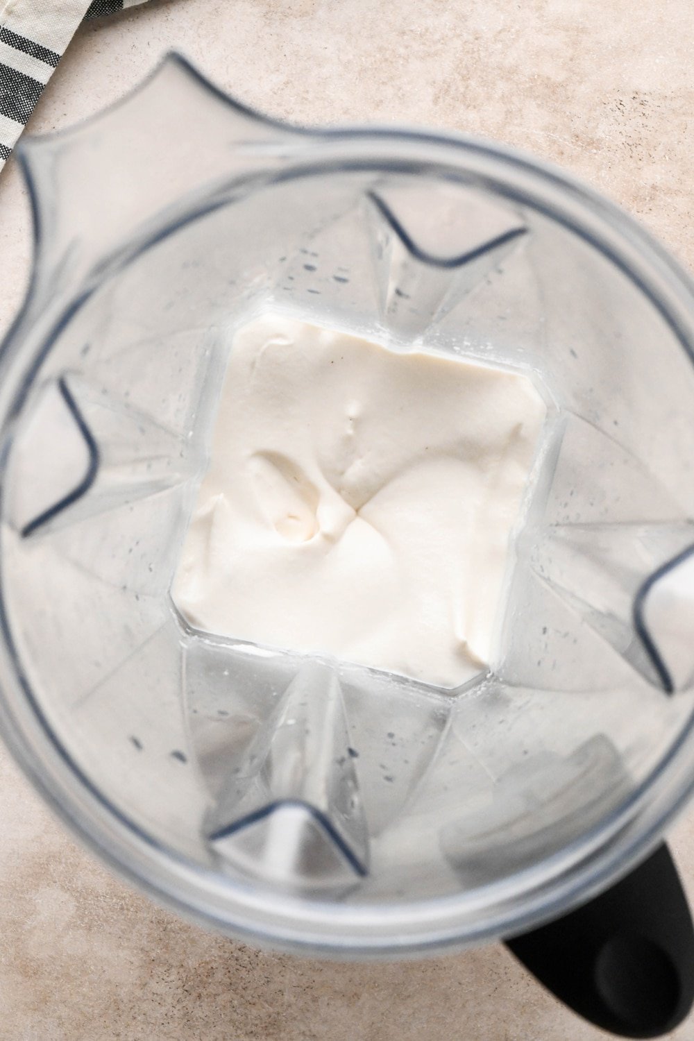 How to make dairy free tzatziki: Cashews blended in the container of a Vitamix blender with lemon juice apple cider vinegar, and kosher salt. 