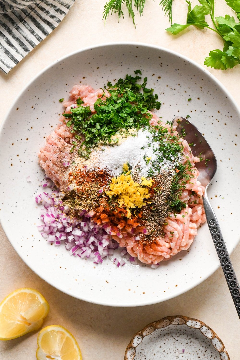 How to make Greek chicken meatballs: Ingredients for meatballs in a large bowl, before mixing.