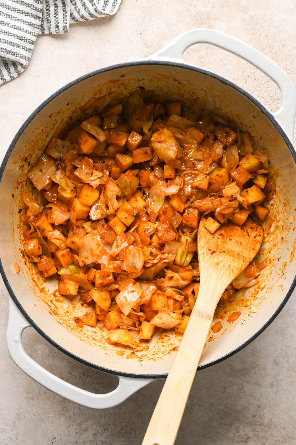 How to make Brothy Sausage and Potato Soup with Kale and Cabbage: Potatoes coated in tomato paste and spices.