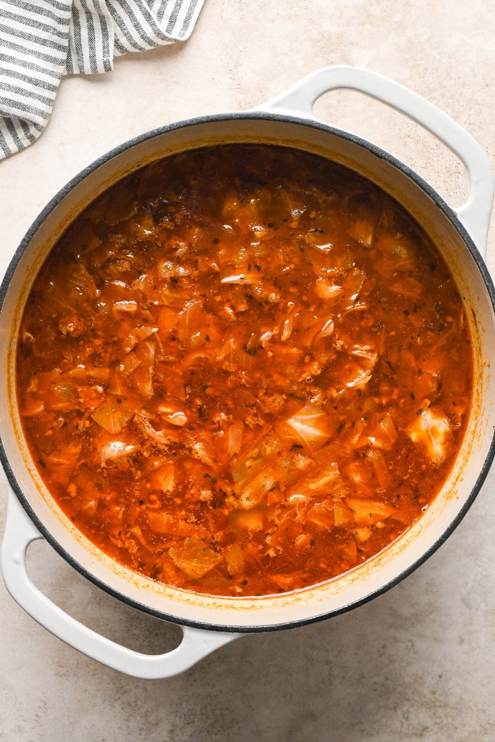 How to make Brothy Sausage and Potato Soup with Kale and Cabbage: Soup after simmering, darker in color, and slightly reduced.